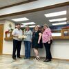 Michael Longhat, vice-president of the Carnegie Wildcat Education Endowment Fund, presents donuts to Bank of Commerce employees, Nicole Clark, Paula Watson and Kelly Williams.